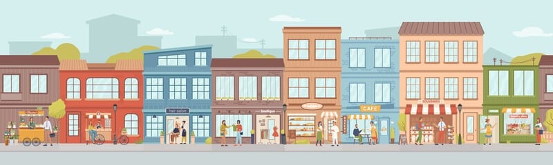 Colorful row of storefronts on a sunny street with pedestrians, cyclists, and a cafe.